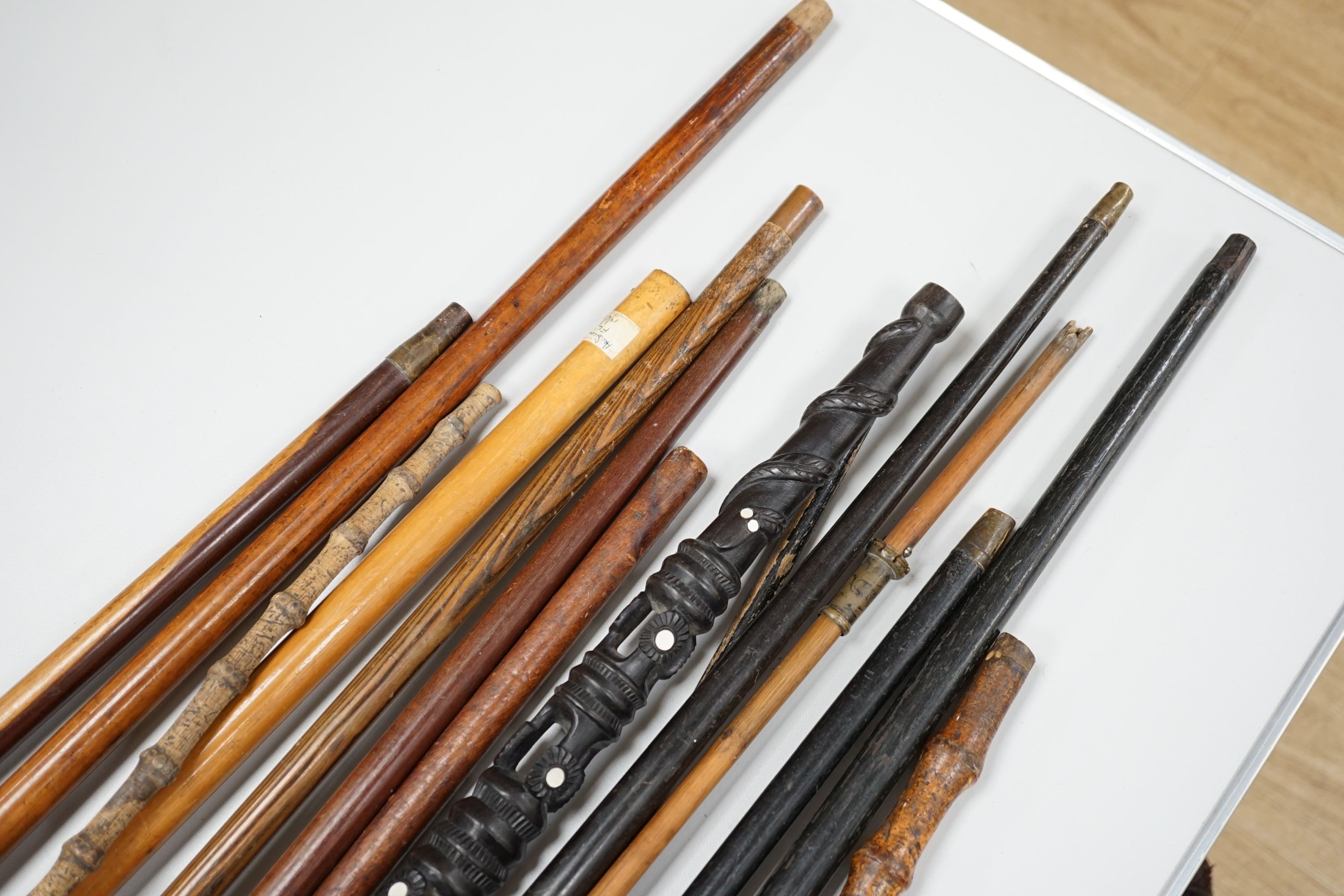 A collection of fifteen assorted walking sticks and canes, many silver mounted